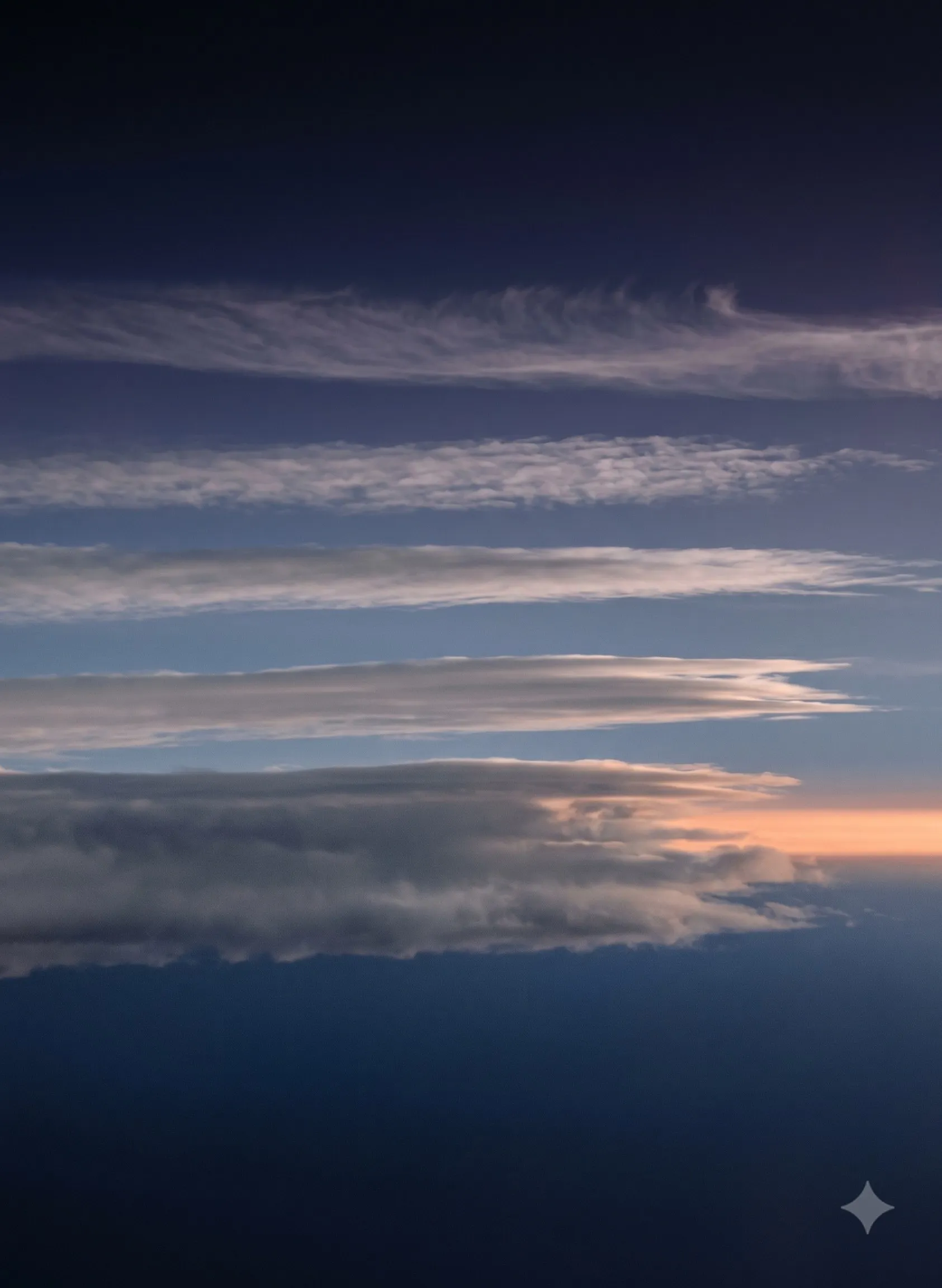 Six horizontal cloud layers stratified at different altitudes, with a warm dawn band cutting across the right edge